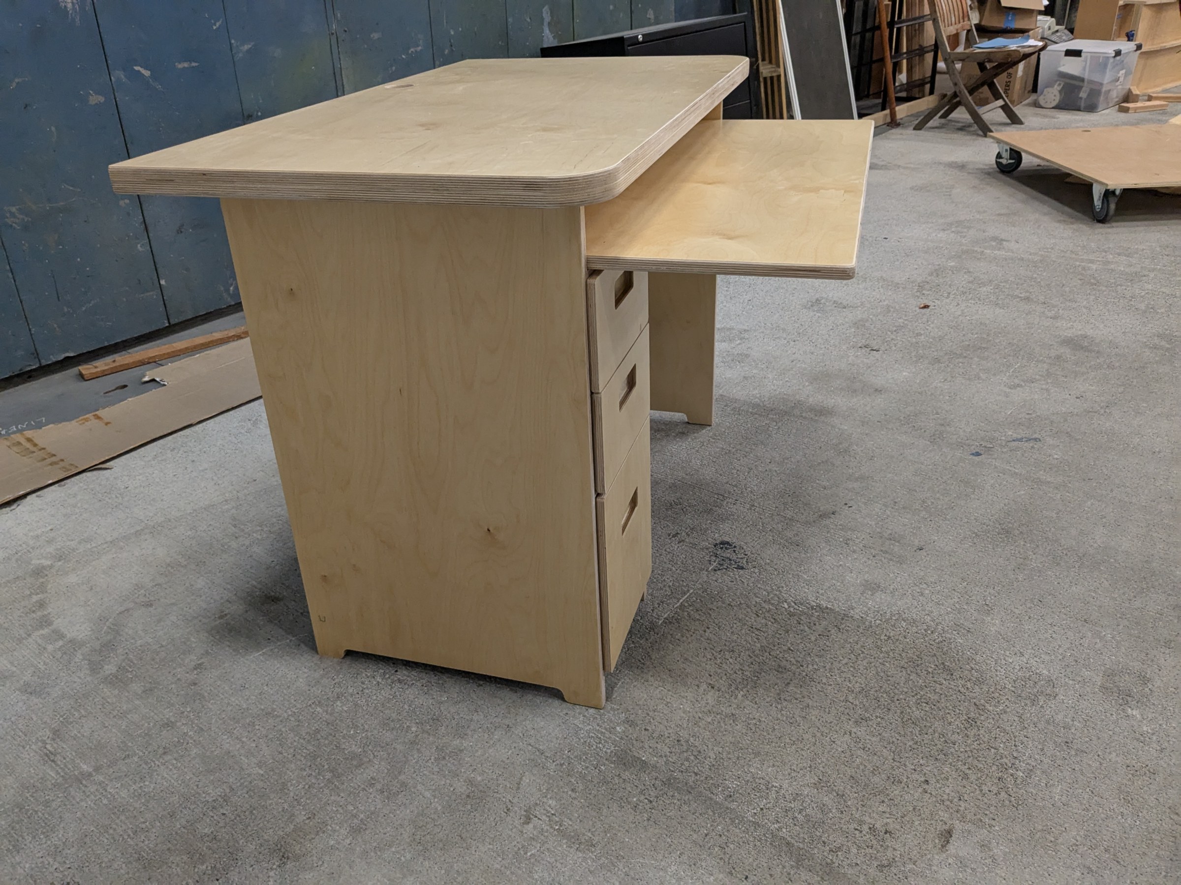 Pull-out tray extended from a desk