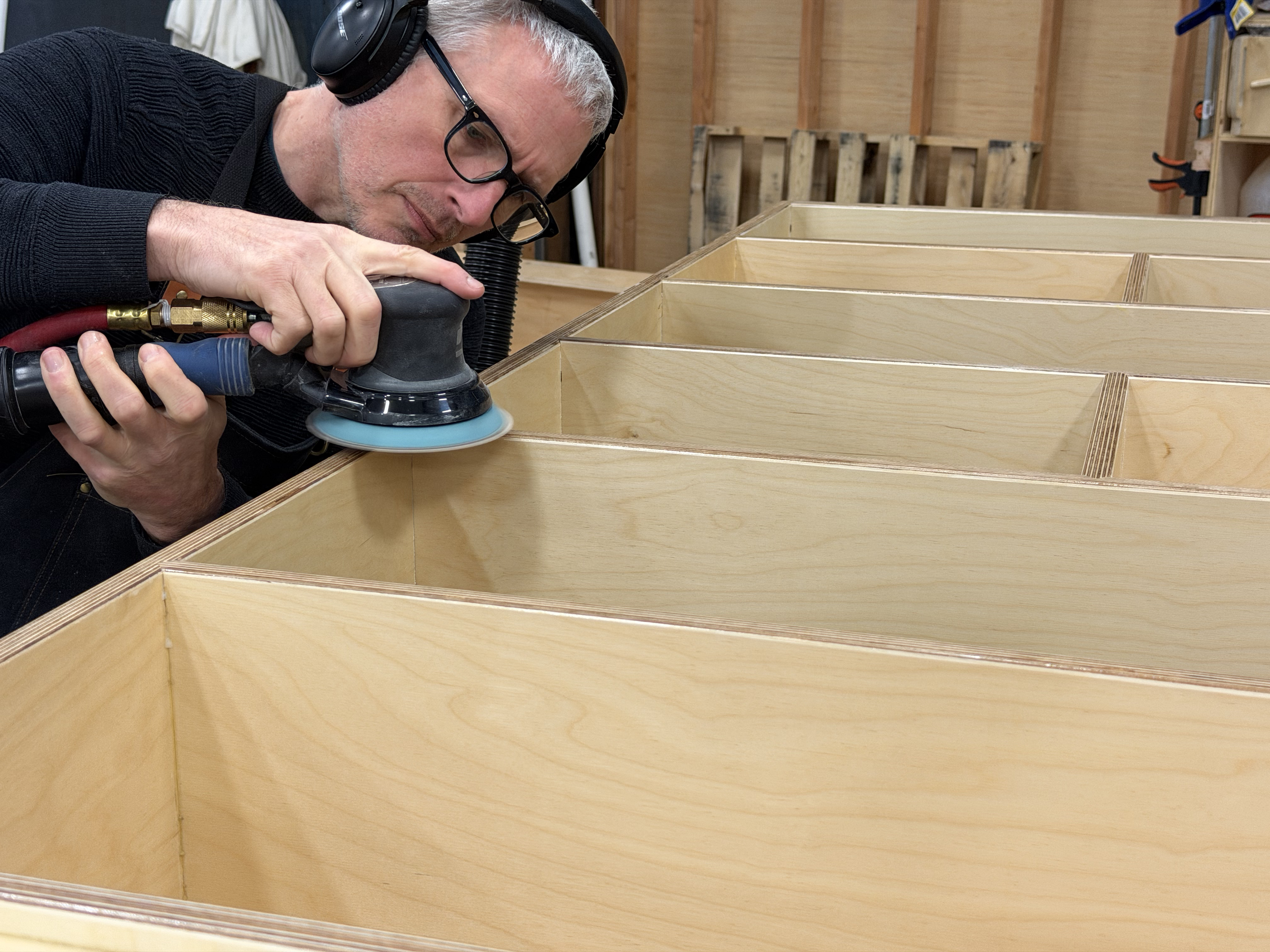 Hand sanding process in the Shelf.me shop.
