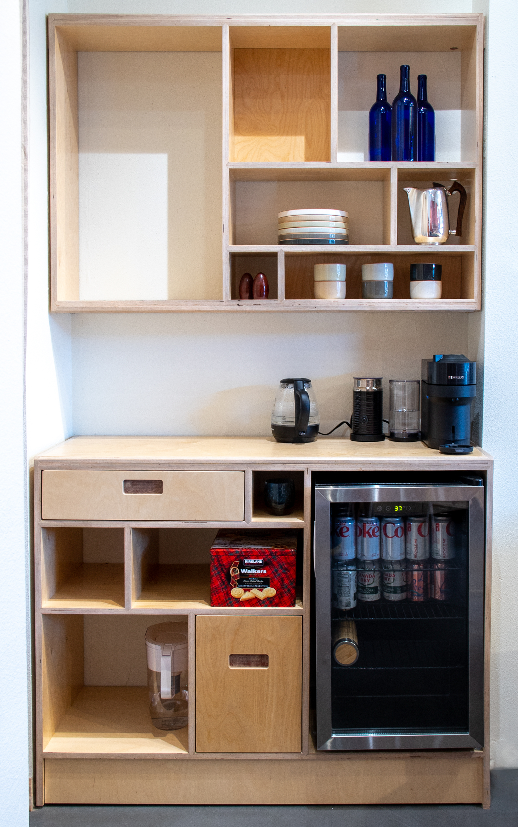 Built-in kitchen area shelving with separate counter top section and hanging storage above