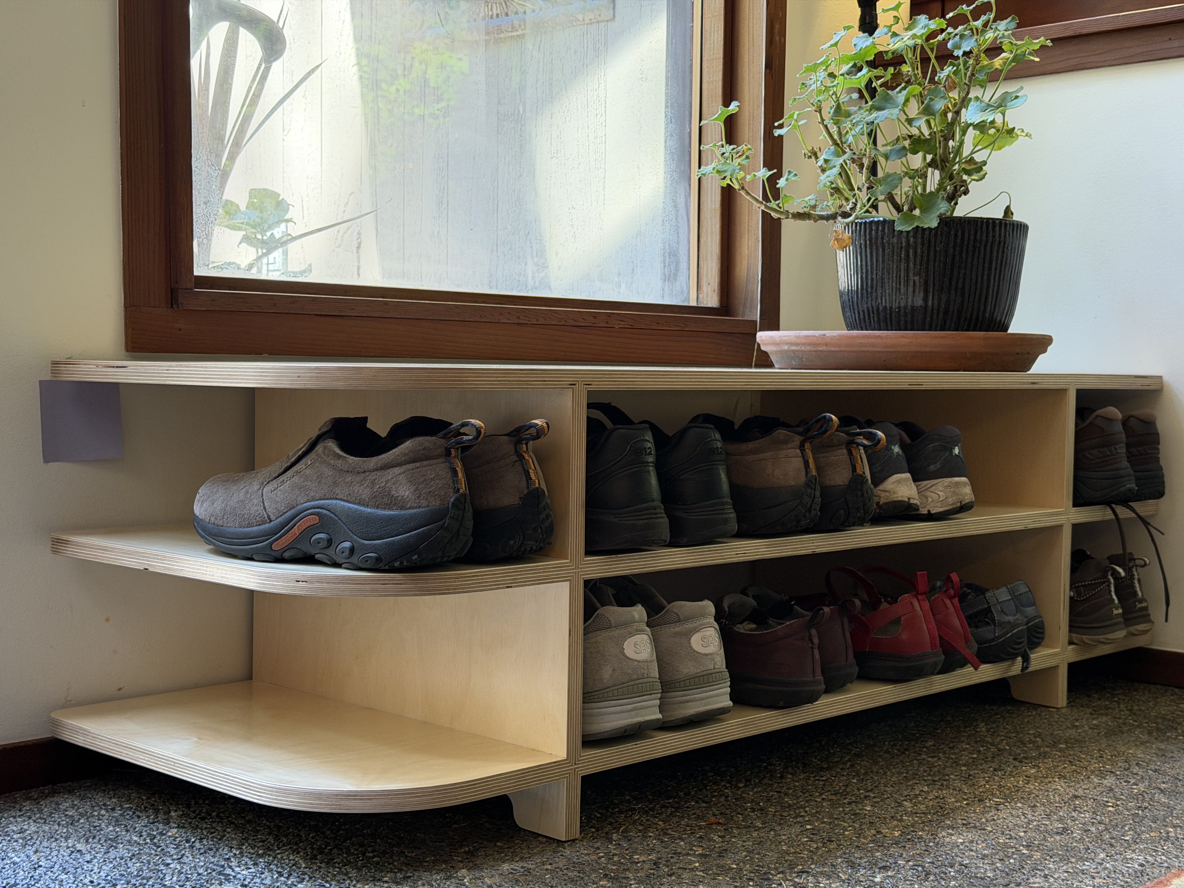 A strong, beautiful storage shelf for shoes by a front door
