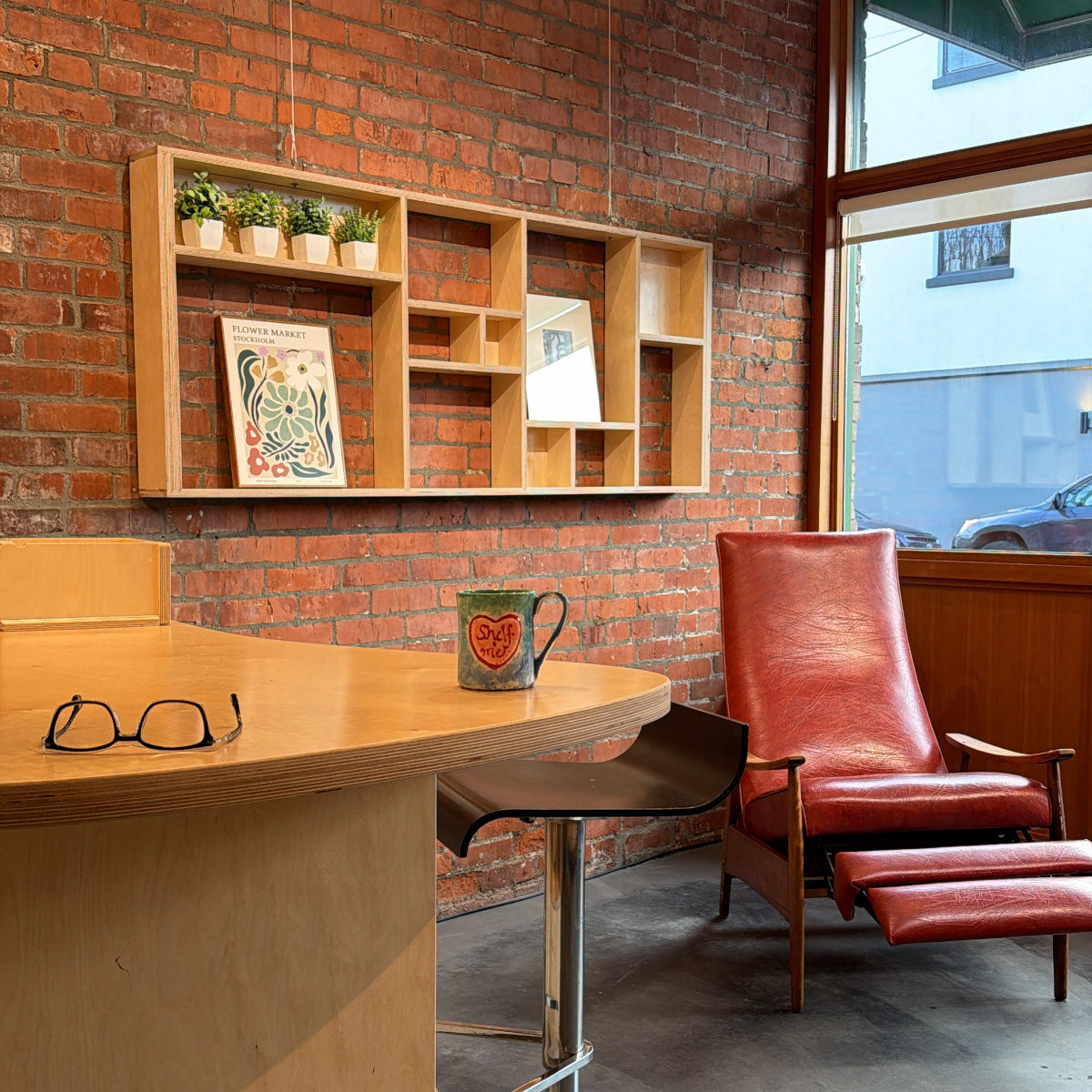 Custom display shelf mounted on a brick wall